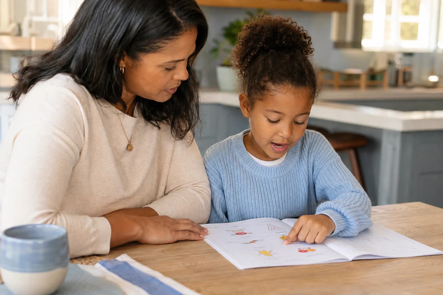 A mother sharing a book and a conversation with her daughter